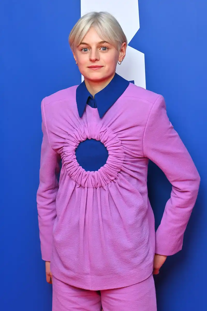 The Crown Emma Corrin Gives a Glimpse at Their Lower Stomach Tattoo Promo Purple Suit British Independent Film Awards
