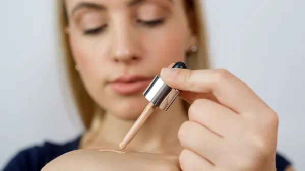 Woman-Putting-On-Liquid-Foundation-Stock-Photo