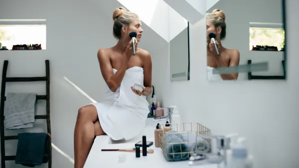 Woman-Putting-On-Makeup-Stock-Photo