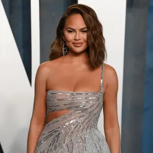 Pregnant Chrissy Teigen Wows in a Skintight Floral Dress