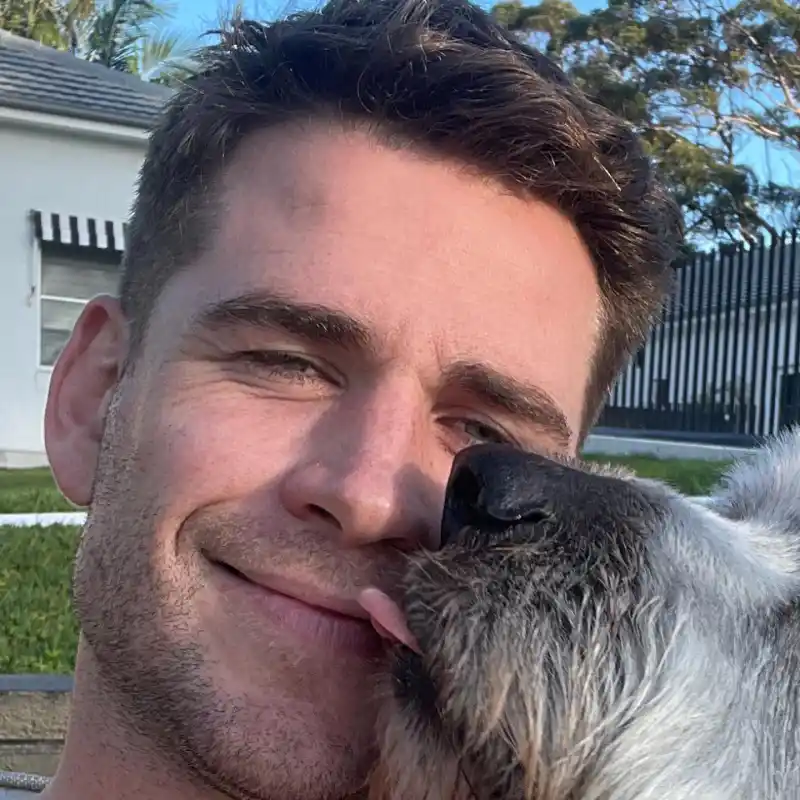 Shirtless Liam Hemsworth Cuddles — and Kisses — His Beloved Dog Dora in Adorable Photo
