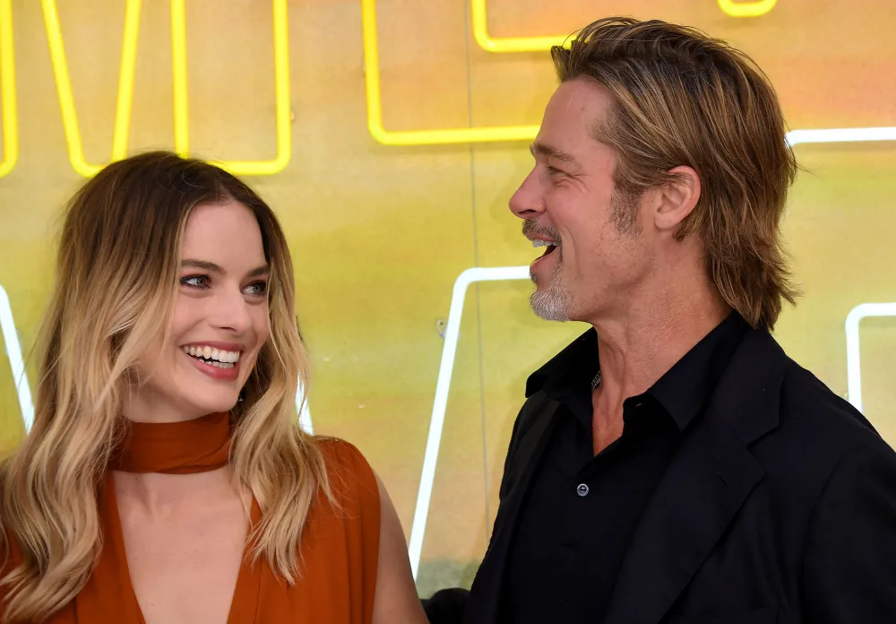 Margot Robbie Reveals She Improvised a 'Babylon' Scene to Kiss Brad Pitt: &lsquo;Sue Me&rsquo; burnt orange dress