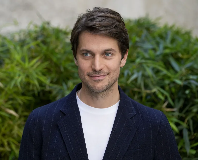 Lucas Bravo Takes American Psycho Themed Runway white tee pin striped suit