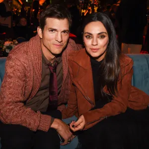 Ashton Kutcher and Mila Kunis’ Relationship Timeline orange jacket