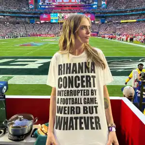 Cara D Wears Team Rihanna Shirt at Super Bowl football field