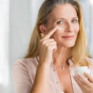 Mature-Woman-Applying-Moisturizer-Stock-Photo