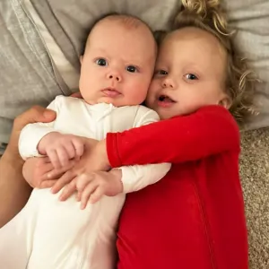 Patrick Mahomes and Brittany Matthews’ Daughter Sterling Cuddles Baby Brother Bronze After Her 1st Birthday Bash: Photos red onesie