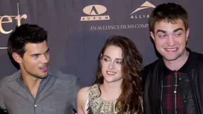 Taylor Lautner Says 'Twilight' Fans' Jacob Vs. Edward Rivalry 'Definitely' Impacted Robert Pattinson Friendship grey shirt