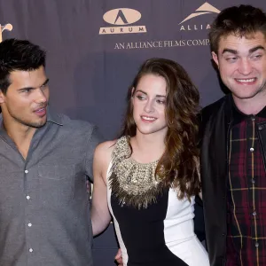 Taylor Lautner Says 'Twilight' Fans' Jacob Vs. Edward Rivalry 'Definitely' Impacted Robert Pattinson Friendship grey shirt