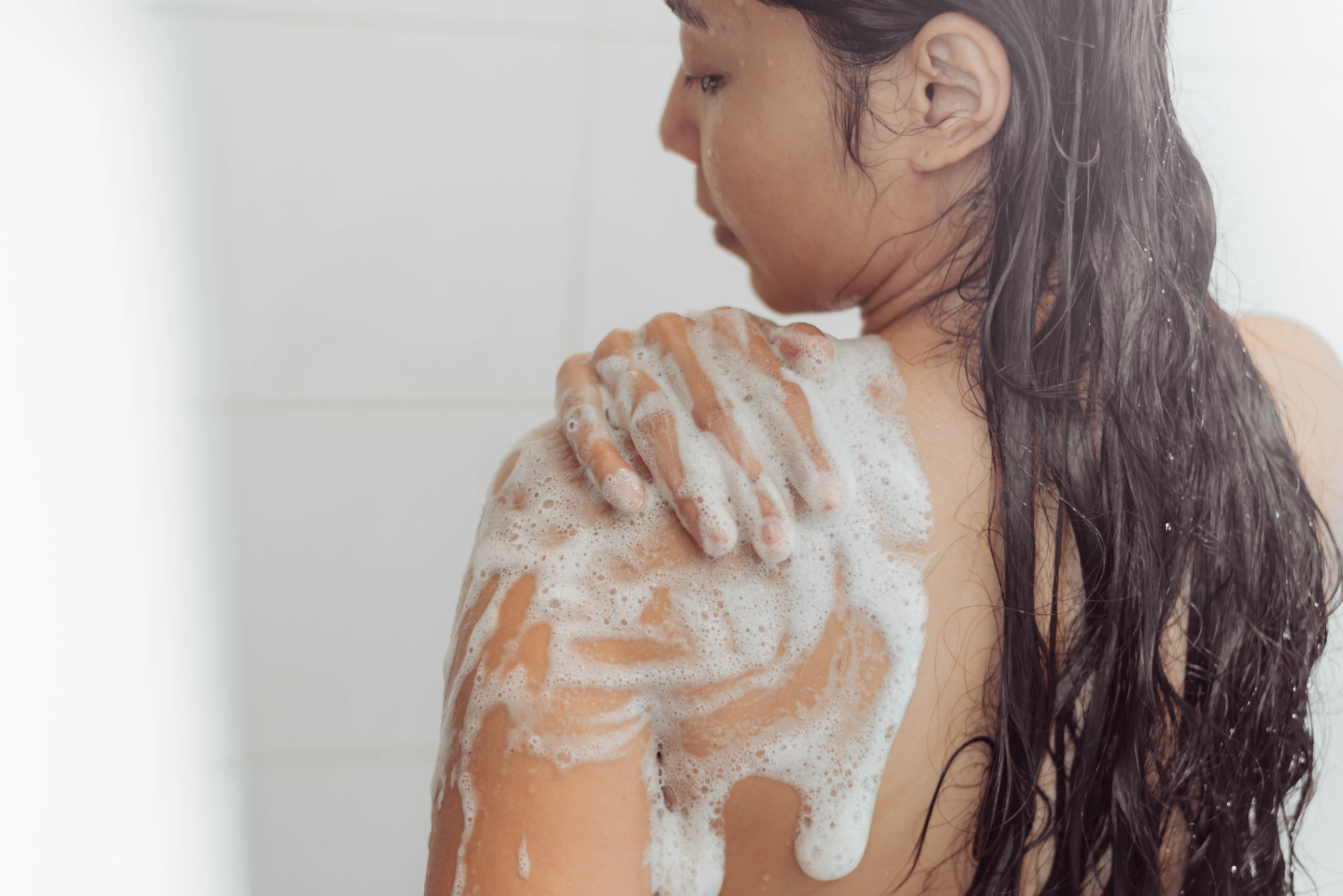 Woman-Using-Body-Wash-Stock-Photo