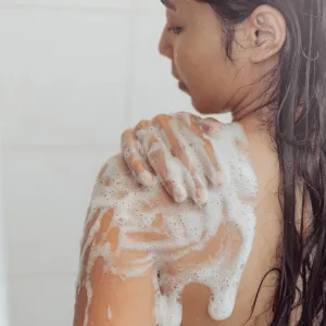 Woman-Using-Body-Wash-Stock-Photo