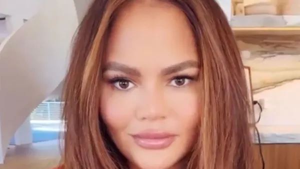 Chrissy Teigen Debuts New Hair Color pink blue robe