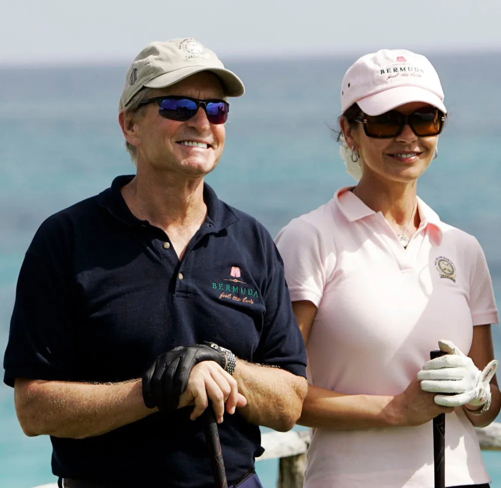 Michael Douglas Says Catherine Zeta-Jones Makes Him Flash Her If He Plays Poorly at Golf