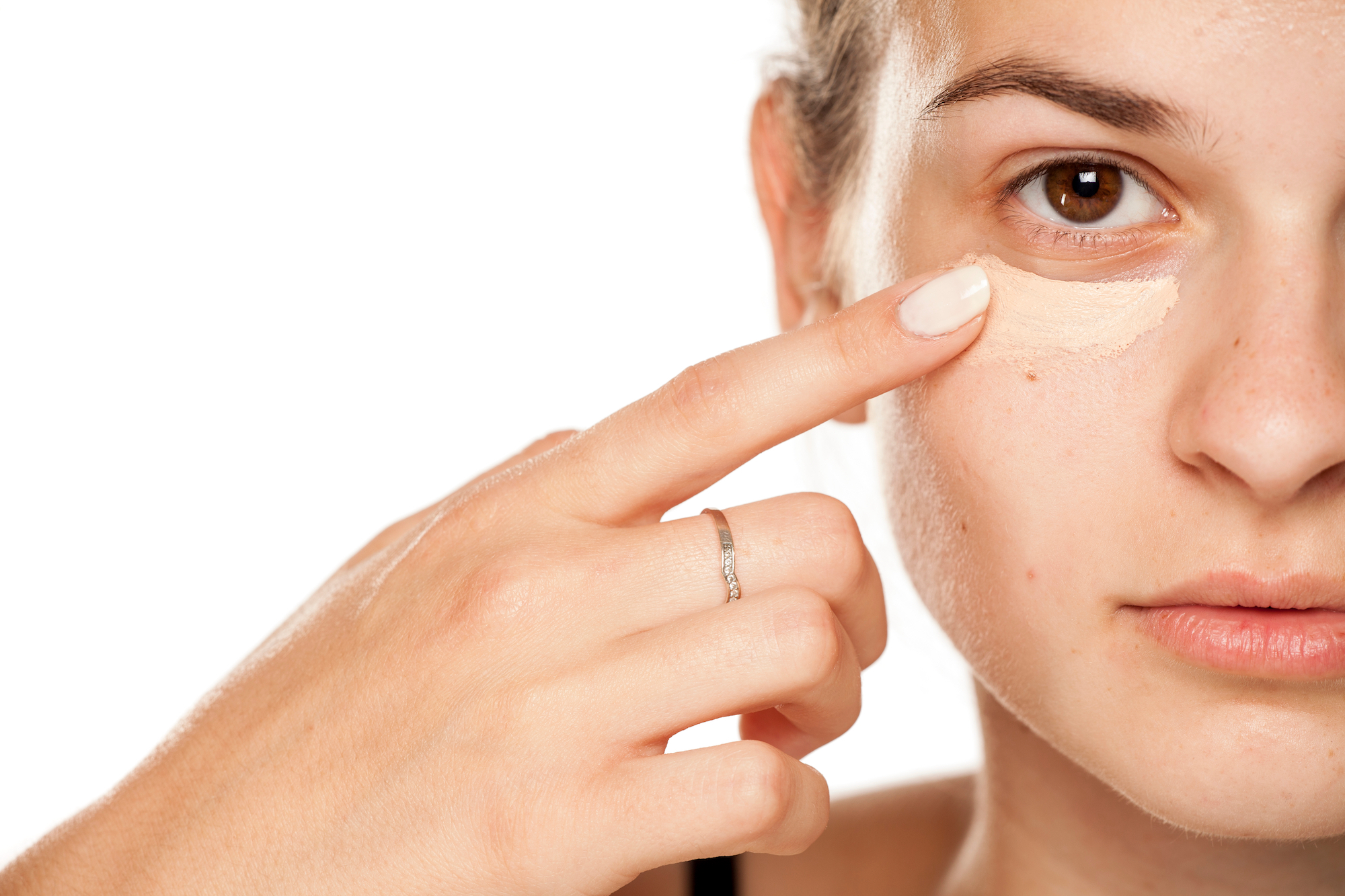 Woman-Applying-Concealer-Stock-Photo