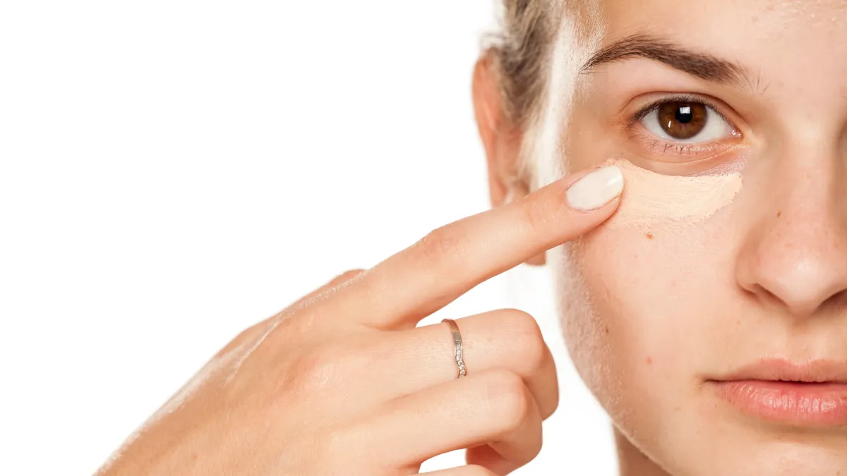 Woman-Applying-Concealer-Stock-Photo