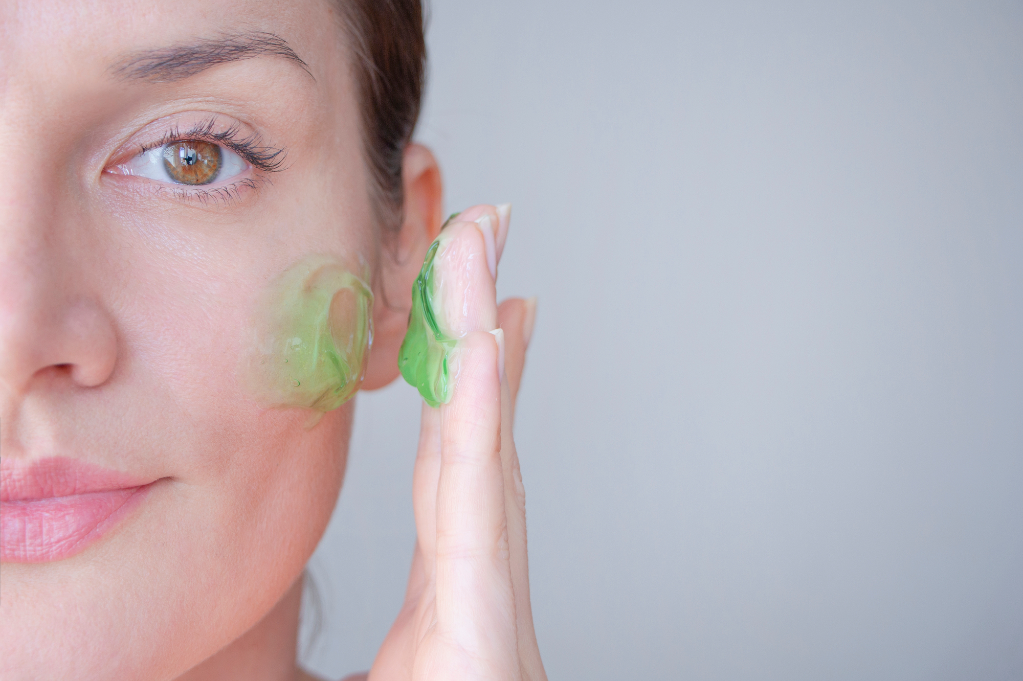 Woman-Applying-Green-Face-Gel-Stock-Photo