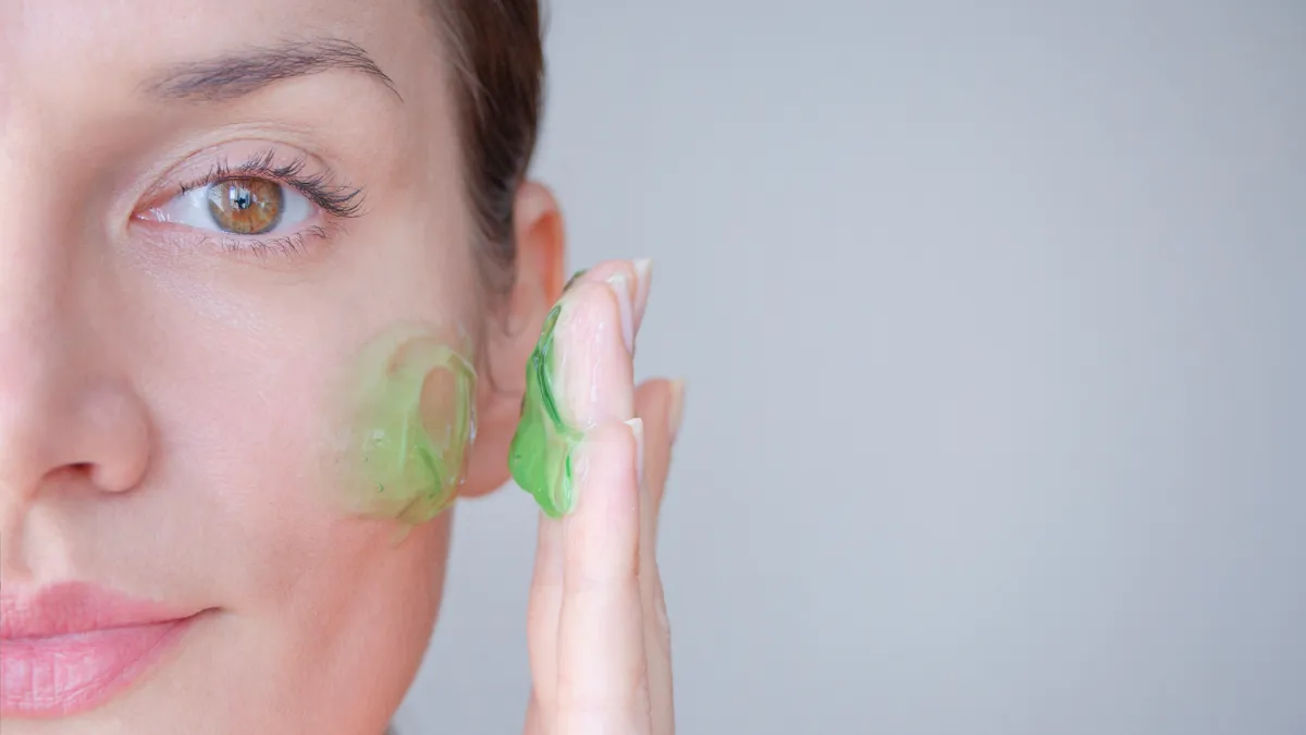 Woman-Applying-Green-Face-Gel-Stock-Photo