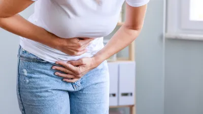 Young-Woman-Experiencing-Bloating-Stock-Photo