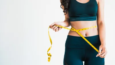 Woman-Measuring-Waistline-Stock-Photo