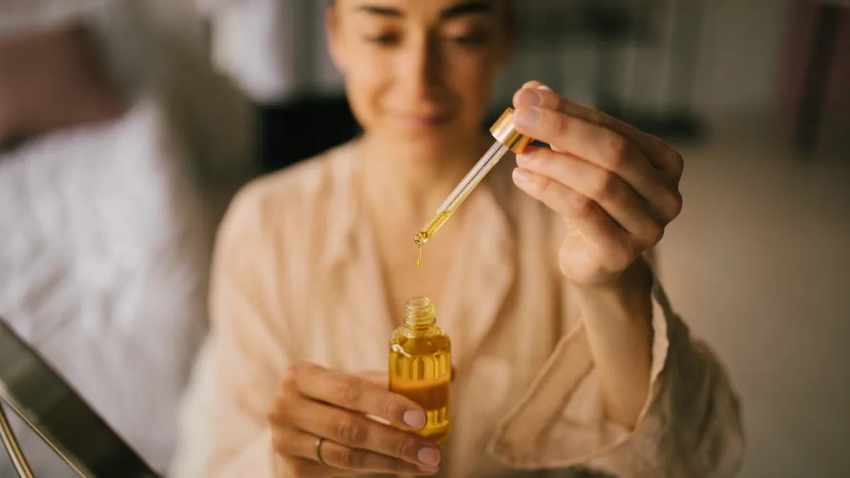 Woman-Applying-Face-Oul-Stock-PhotoWoman-Applying-Face-Oul-Stock-Photo