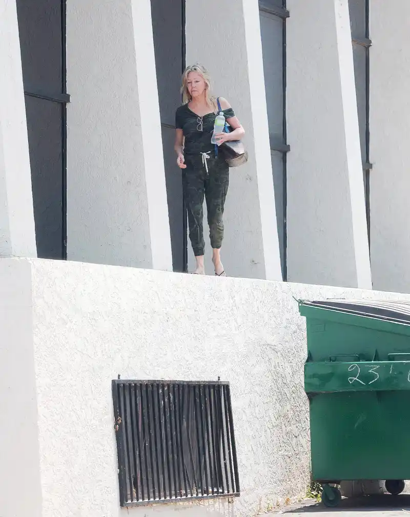 Heather Locklear-197 balancing herself along the edge of a tall office building whilst appearing to be in some sort of distress