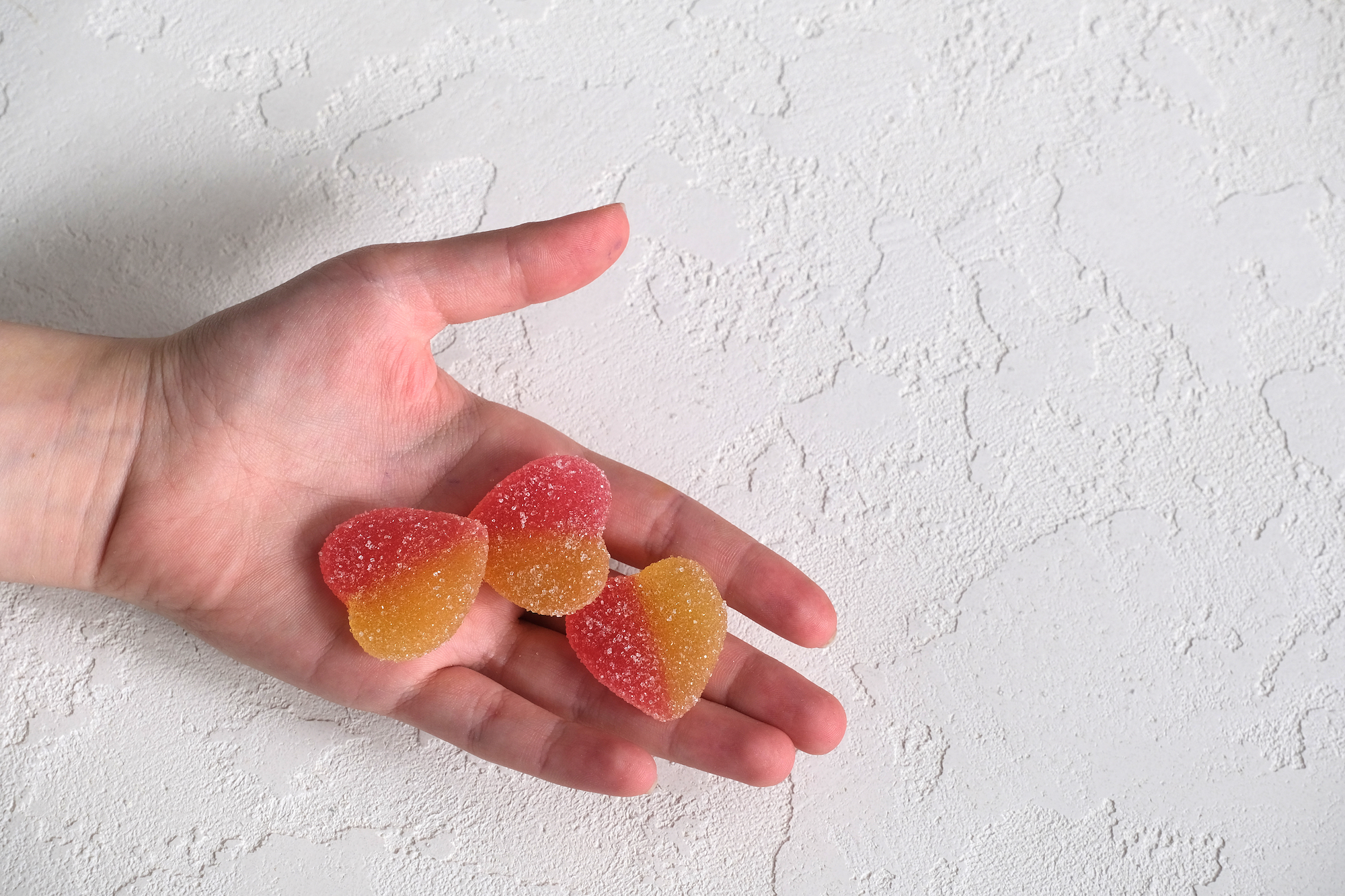 Two-Colored-Gummies-In-Hand-Stock-Photo
