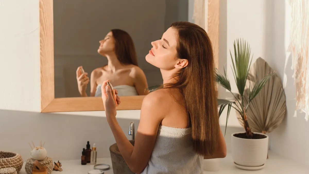 Woman-Spraying-Perfume-Stock-Photo