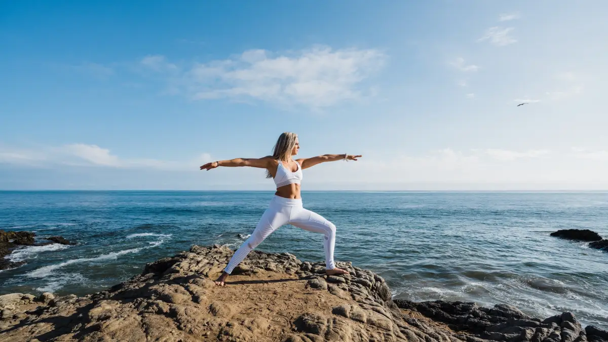 Woman-Working-Out-By-Ocean-Stock-Photo