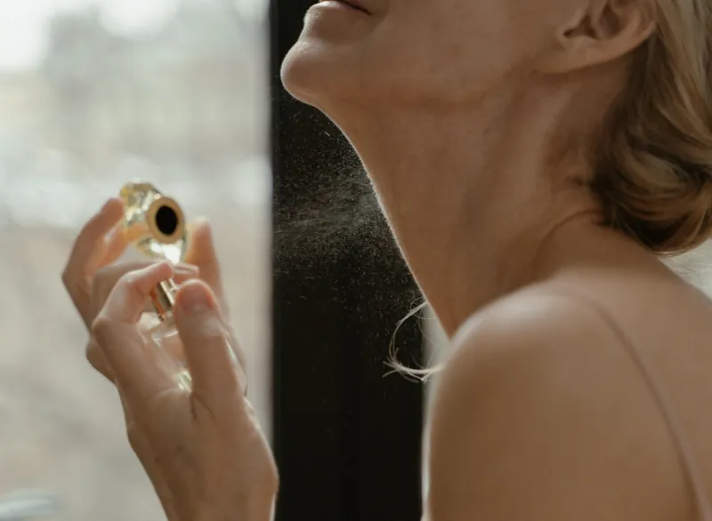 A Woman Spraying Perfume