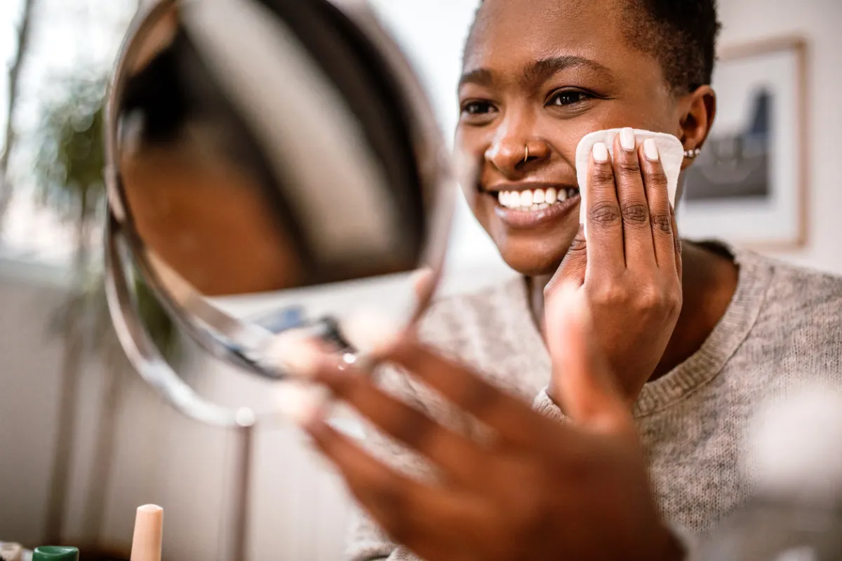 Someone removes makeup with a gentle towel