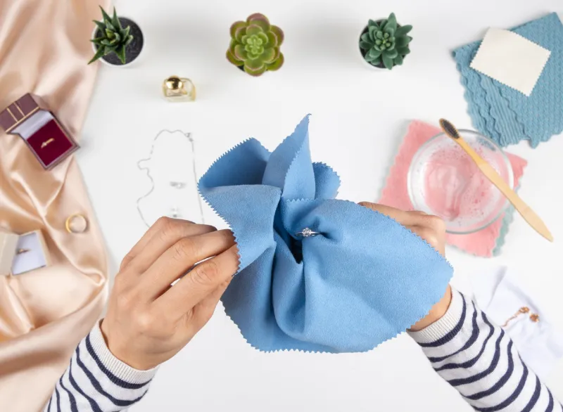 Woman cleaning her jewelry