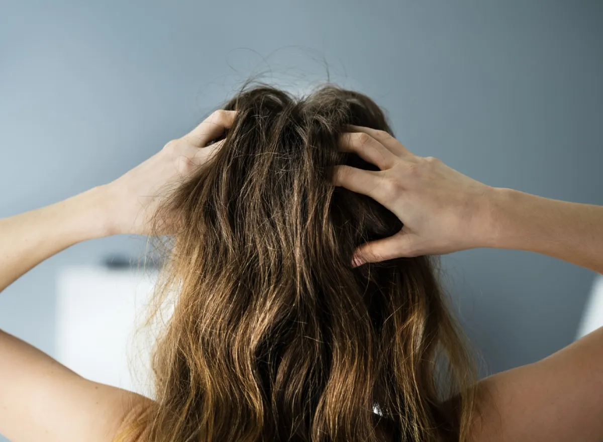 Woman scratching her head