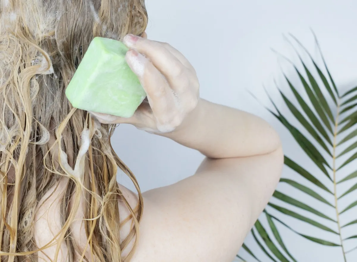 Woman washing her hair with a shampoo bar