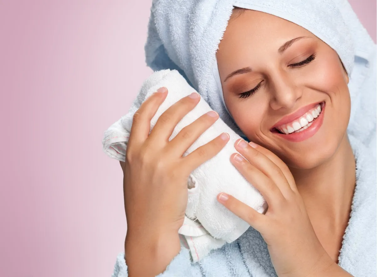 Smiling woman with her hair wrapped in a microfiber hair towel