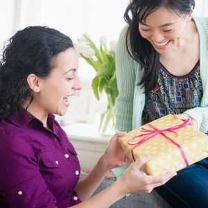 Woman giving friend birthday present