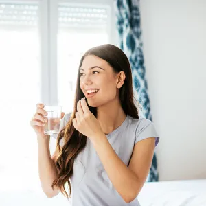 Healthy young woman taking supplements