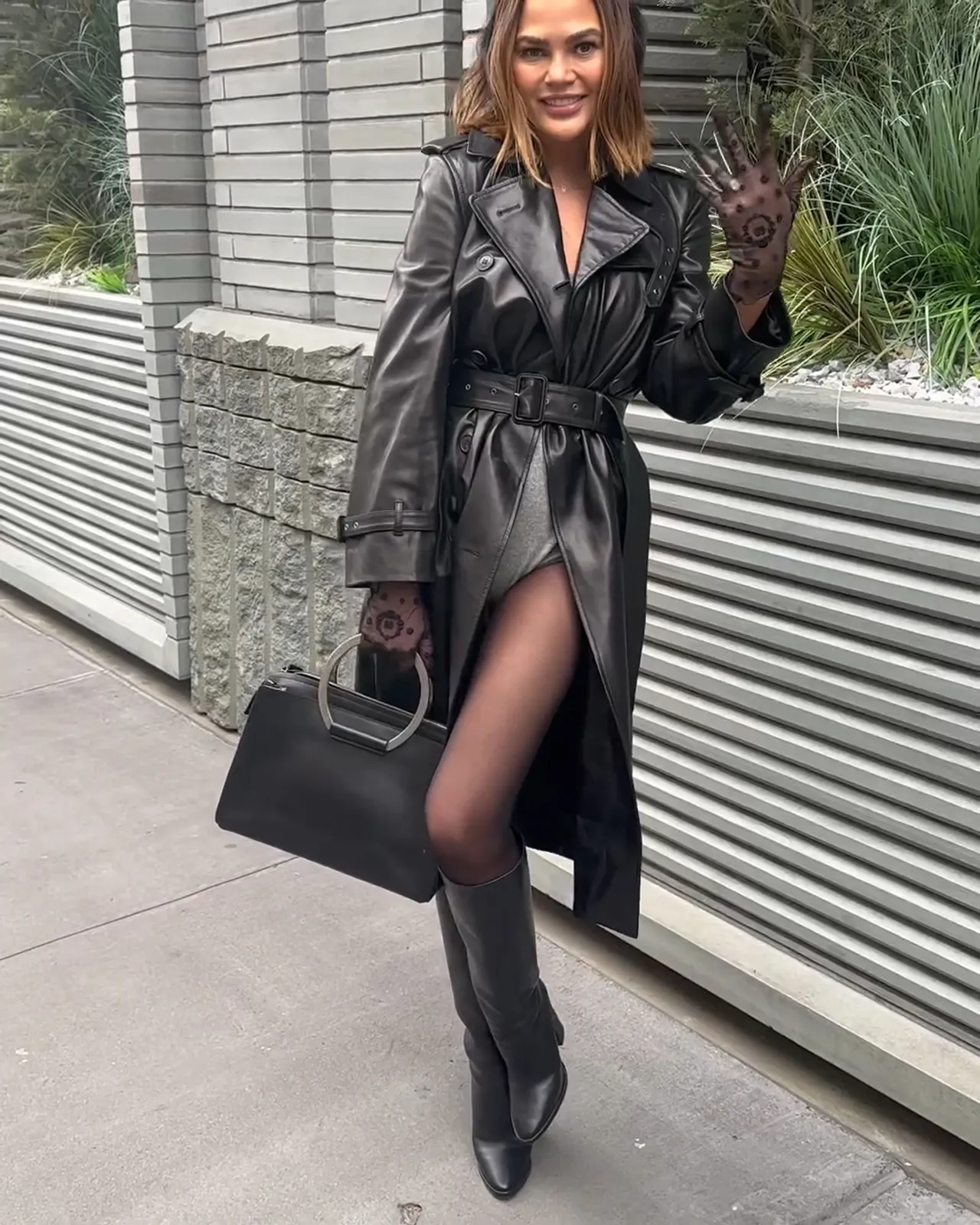 Chrissy Teigen Goes Pantless Under Leather Trench Coat for Christmas Outing in NYC