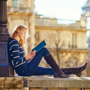 Beautiful woman in Paris, reading a book
