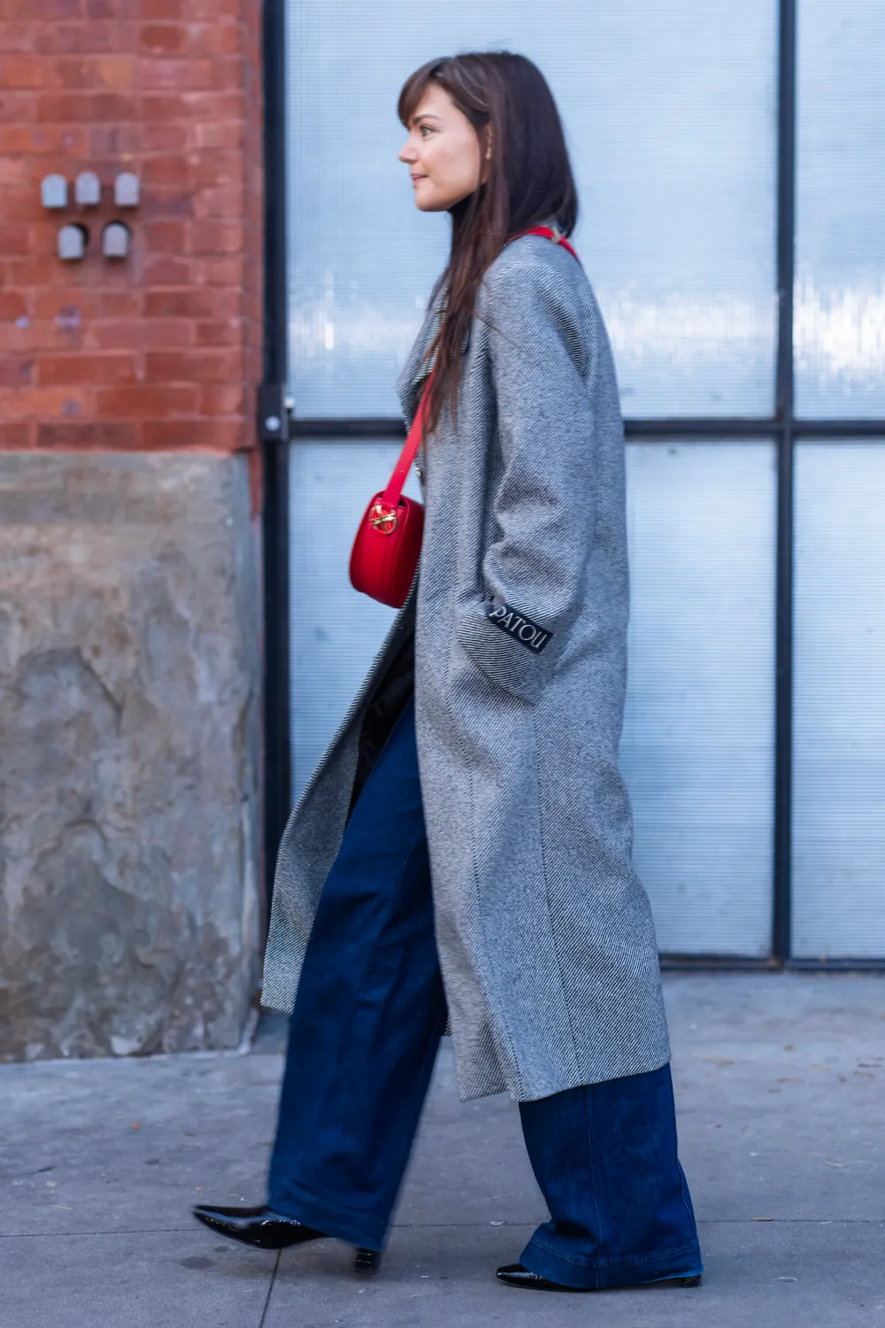 Katie Holmes Adds a Pop of Festive Red to a Neutral Winter Outfit