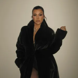 FEATURE Kourtney Kardashian Threw on a Cozy Coat for Christmas Because Her Boobs Are Filled With Milk