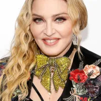 Madonna Smiling at Camera wearing Gold Sparkly Bow Necklace