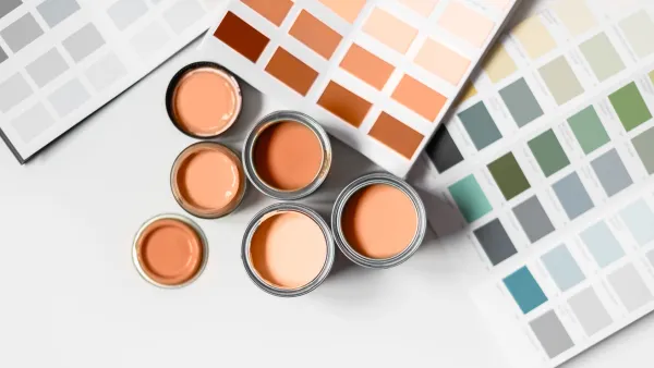 Tiny sample paint cans during house renovation, process of choosing paint for the walls, Peach Fuzz color of the year 2024, color charts on background