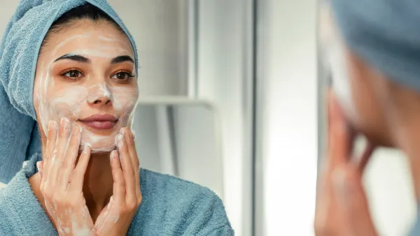 Reflection in a mirror beautiful woman washing her face