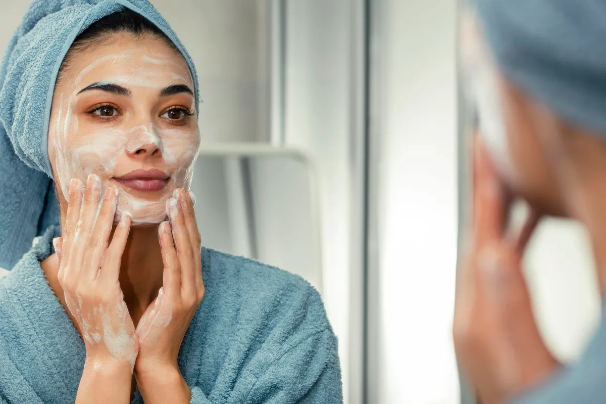 Reflection in a mirror beautiful woman washing her face