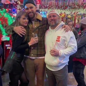 Taylor Swift and Travis Kelce Snuggle Up at Holiday Bash