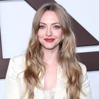 Amanda Seyfried Looking at camera Smiling wearing cream colored blazer and matching top