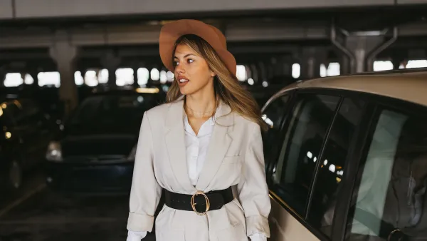 Elegant young woman walking on shopping mall parking lot