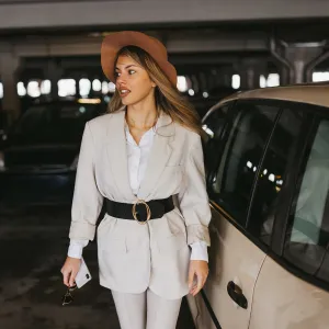 Elegant young woman walking on shopping mall parking lot