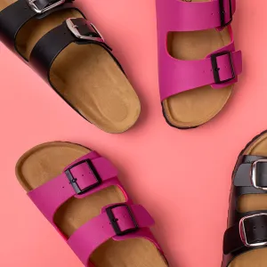Trendy fashion footwear mockup. Leather pink and black sandals birkenstocks on pink background top view flat lay. Unisex summer shoes, genuine leather flip flops with cork soles