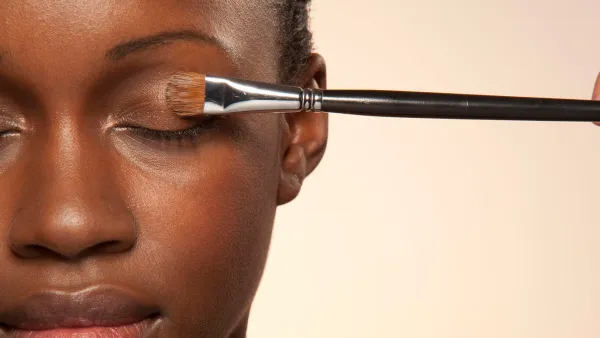 Woman with eye make up brush on eye